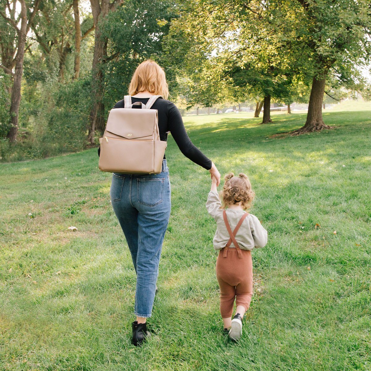 Aspen Classic Diaper Bag II in stone being worn as a crossbody bag.
