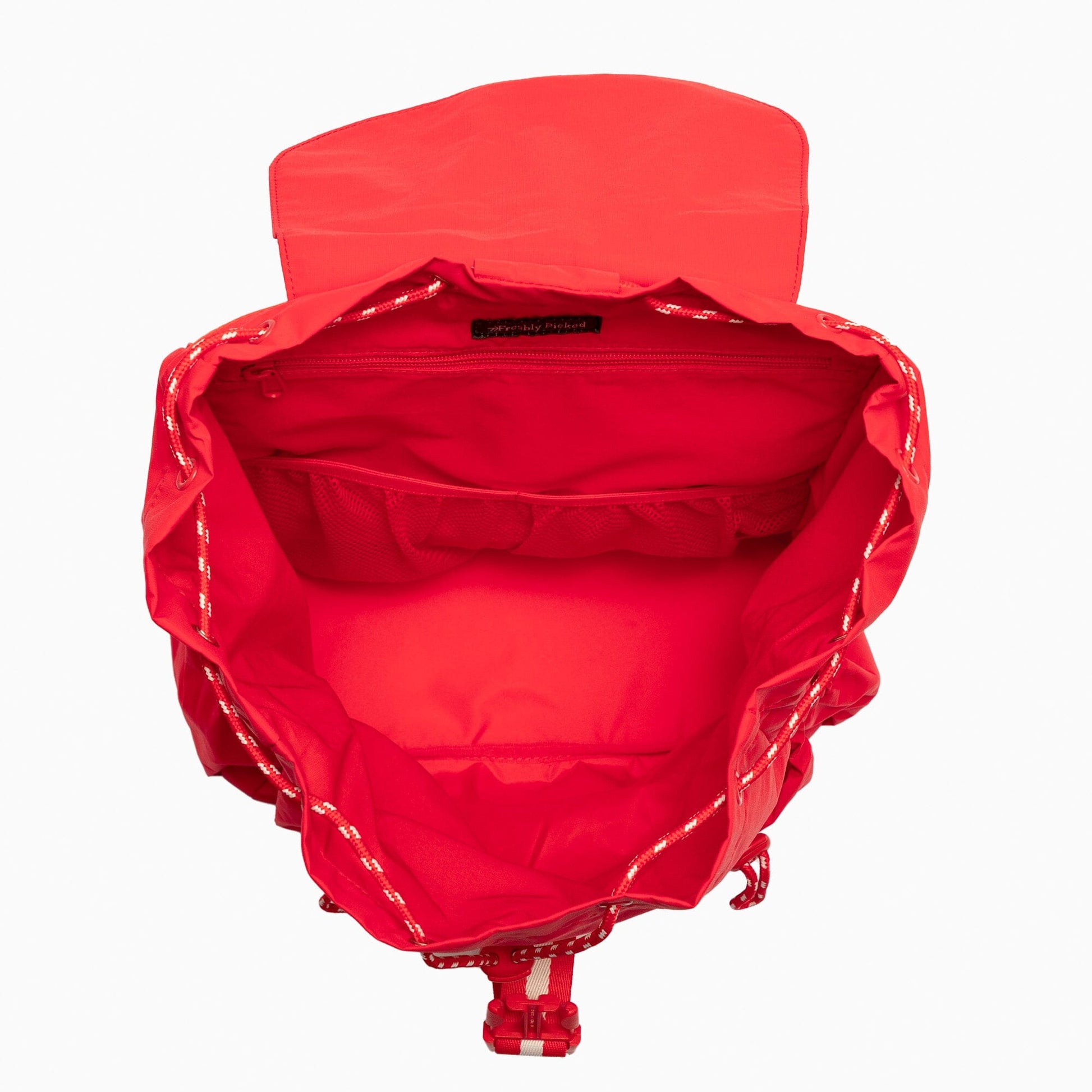 Open view of the Cherry Motion Backpack's red interior.