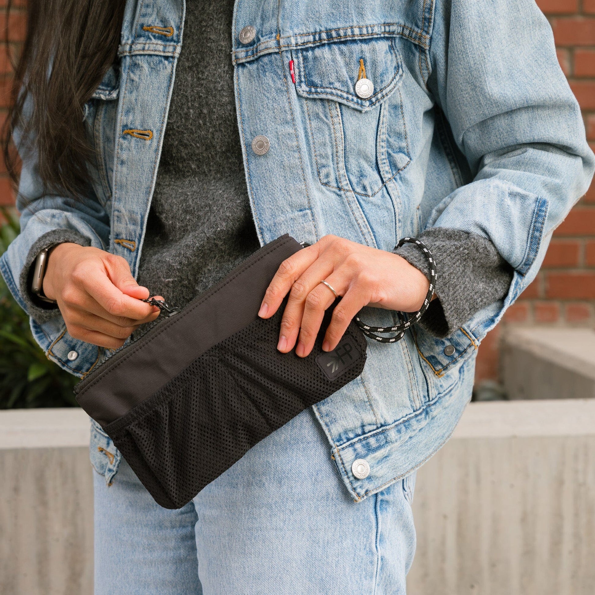 Jet Motion Wristlet Pouch in black nylon with wrist strap and mesh pockets.