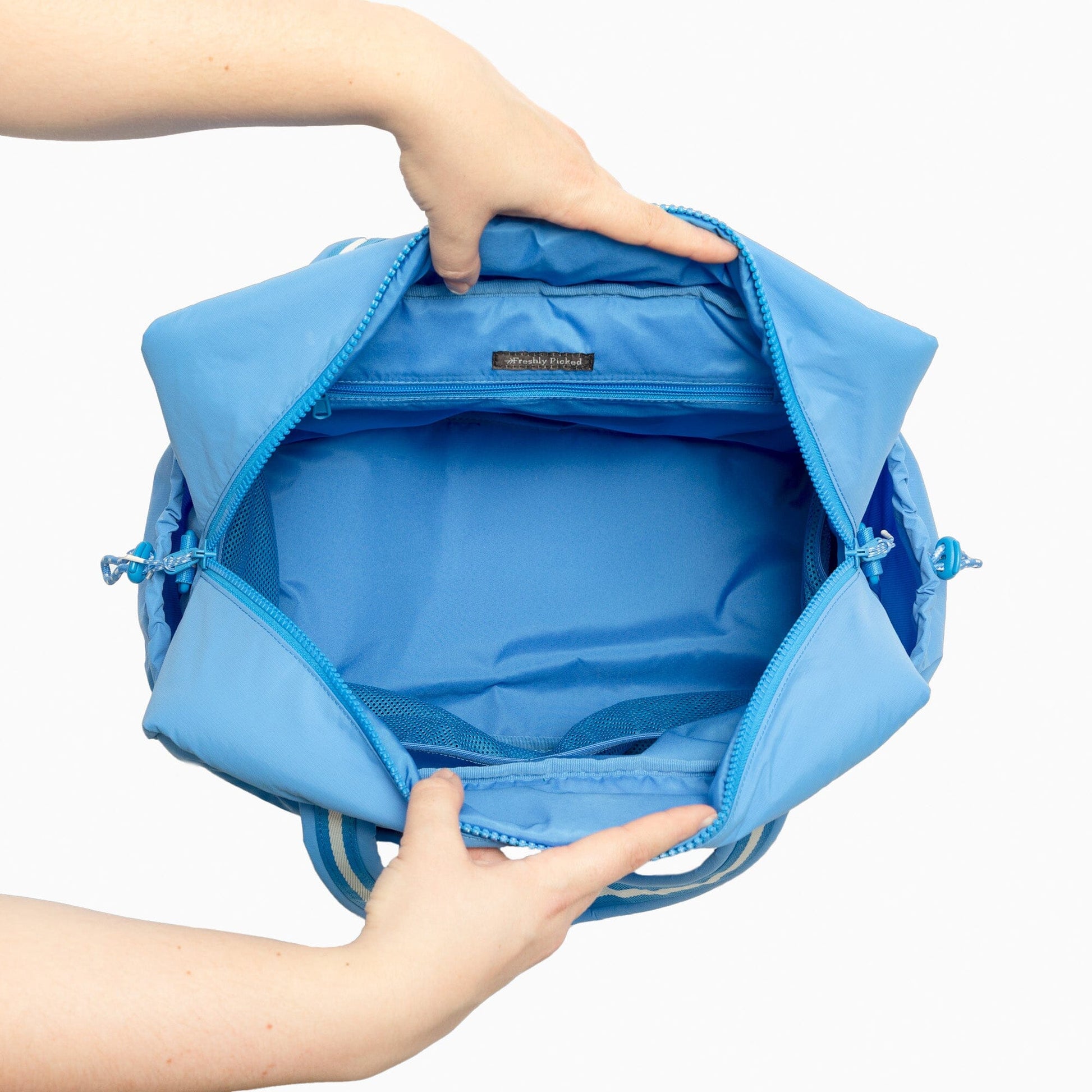 Interior view of the blue Wave Motion Overnight Duffle bag.