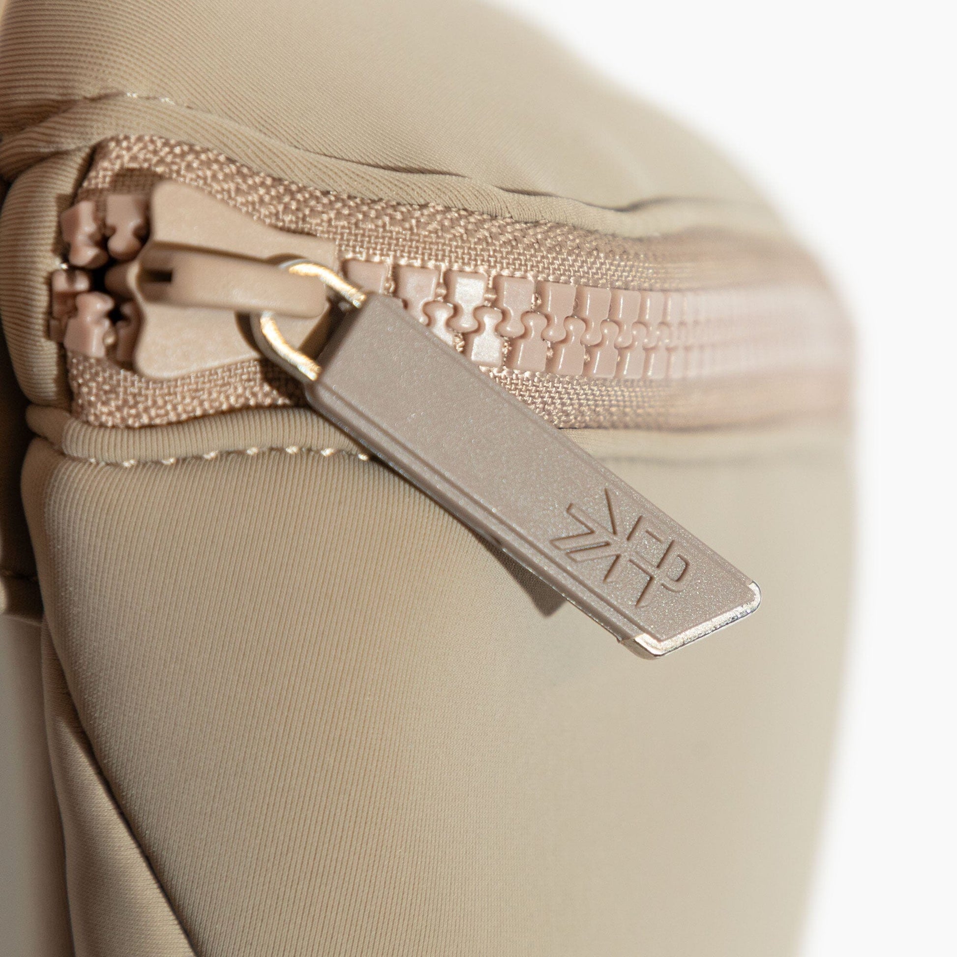 Close-up of the Aspen Seoul Neoprene Play Pack zipper and logo detail.