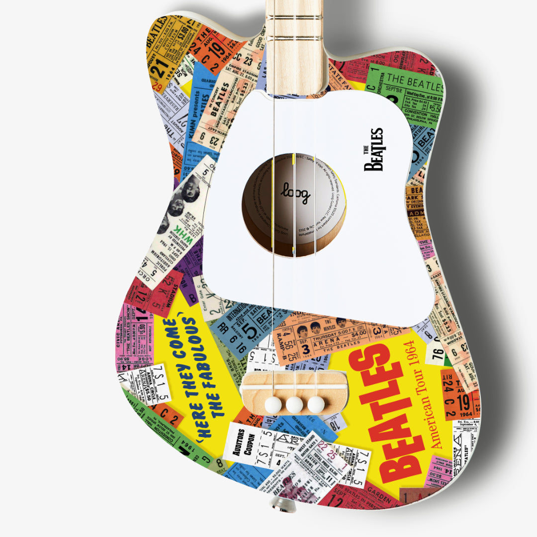 Close-up of The Beatles Loog Mini Guitar showing ticket stub design.