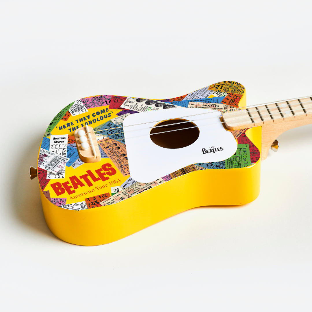 Angled view of The Beatles Loog Mini Guitar showing yellow sides.