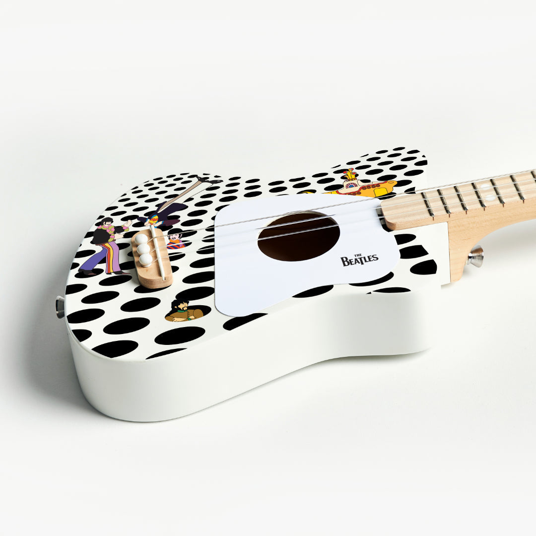 Detail of The Beatles Loog Mini guitar showing the bridge and polka dot pattern