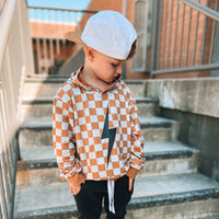 Close up of rust checkered spark hoodie