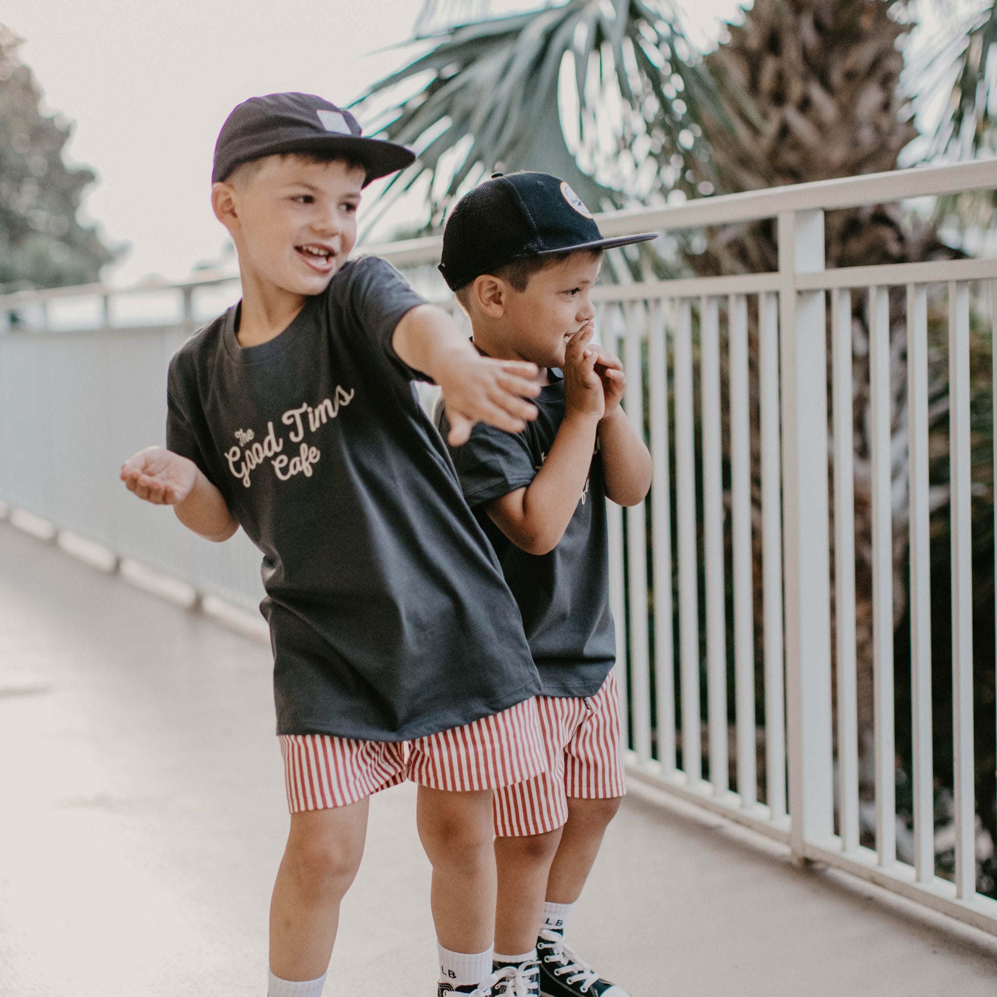 Boy wearing The Good Times Cafe Tee with a cool graphic on the back.