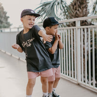 Boy wearing The Good Times Cafe Tee with a cool graphic on the back.