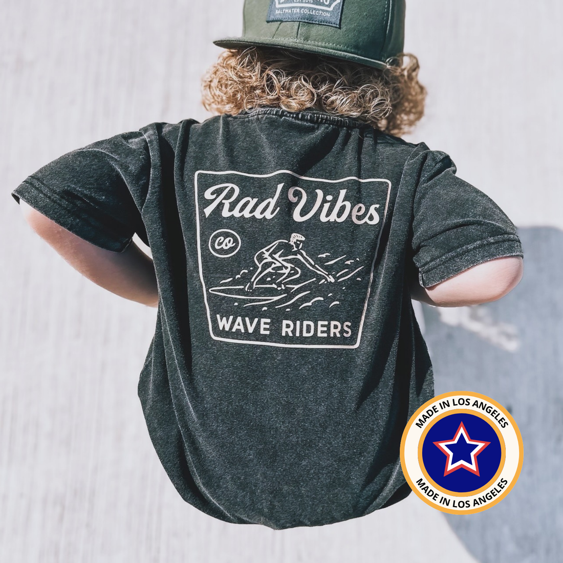Back view of Mavericks Tee in vintage black with 'Rad Vibes' graphic.