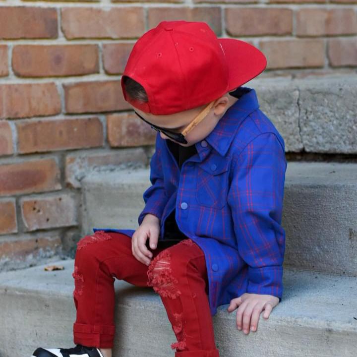 Boy in blue and red plaid Kids Fast and Free Flannel with jeans and red sneakers