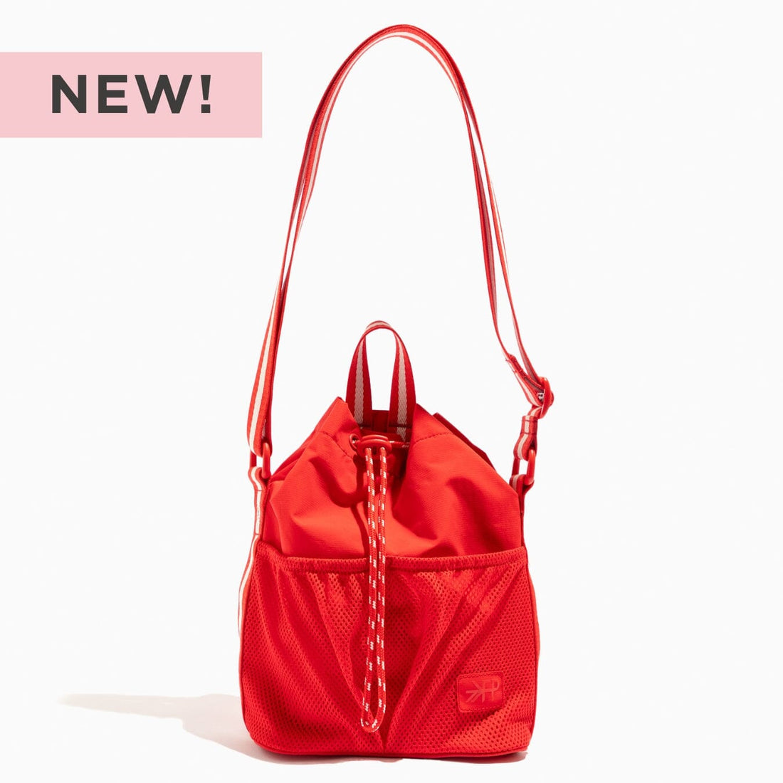 NEW! Cherry Motion Bucket Crossbody bag in bright red with a drawstring closure and white striped strap.