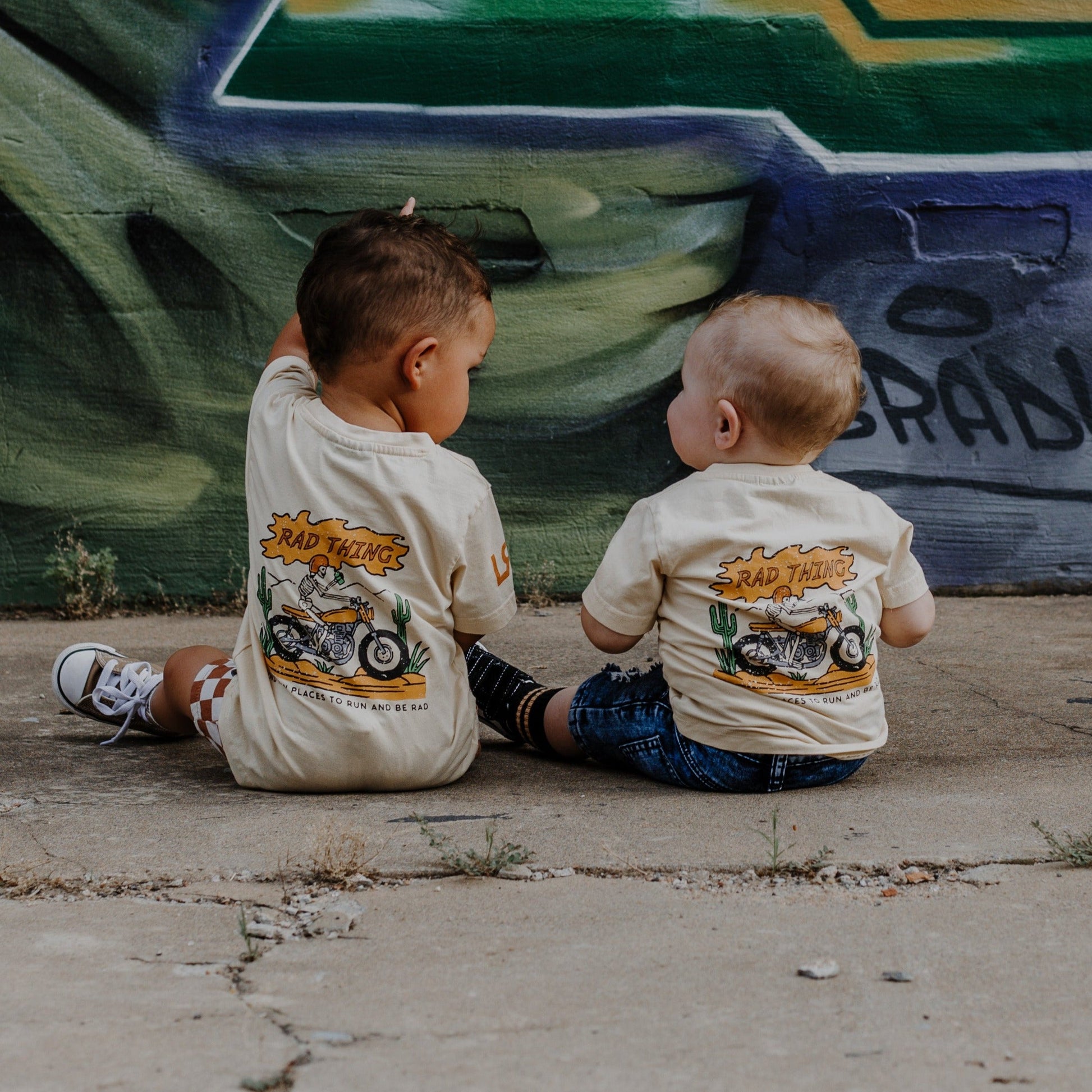 Toddler boy wearing 'Where the Rad Things Are' graphic tee.
