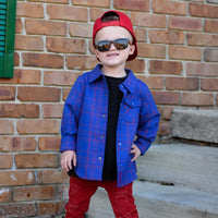 Boy in blue and red plaid Kids Fast and Free Flannel with jeans and red sneakers