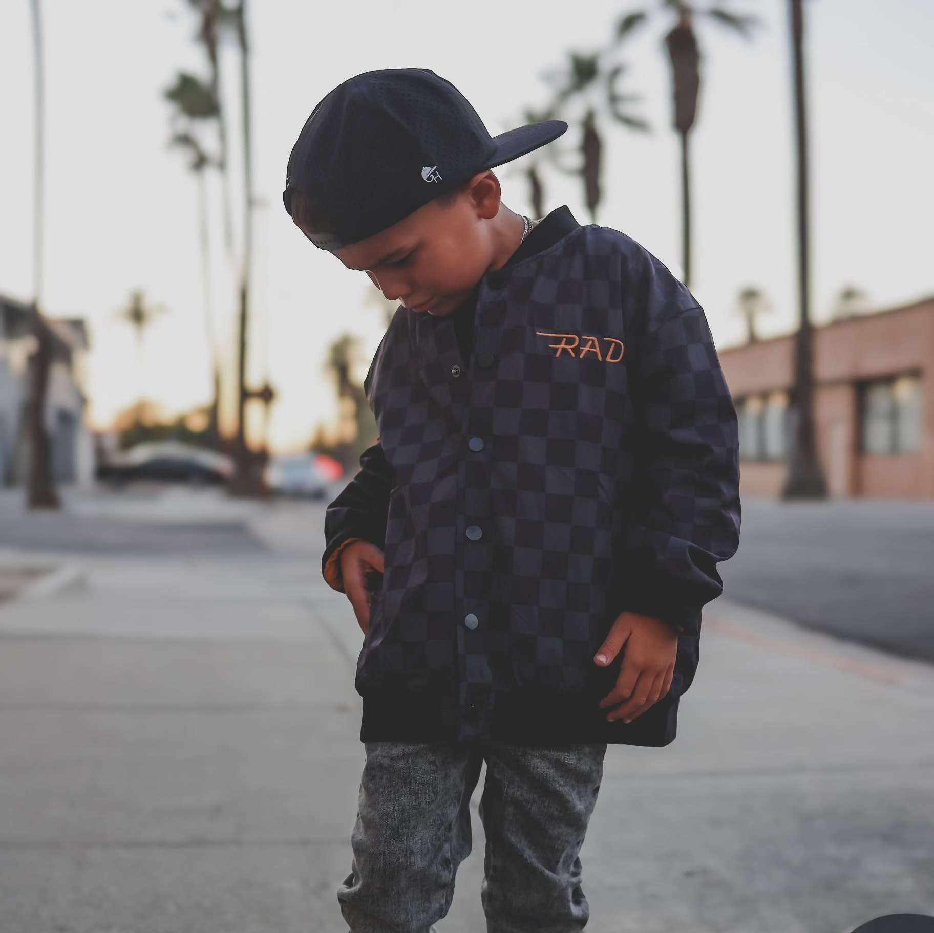 Boy in checkered letterman jacket