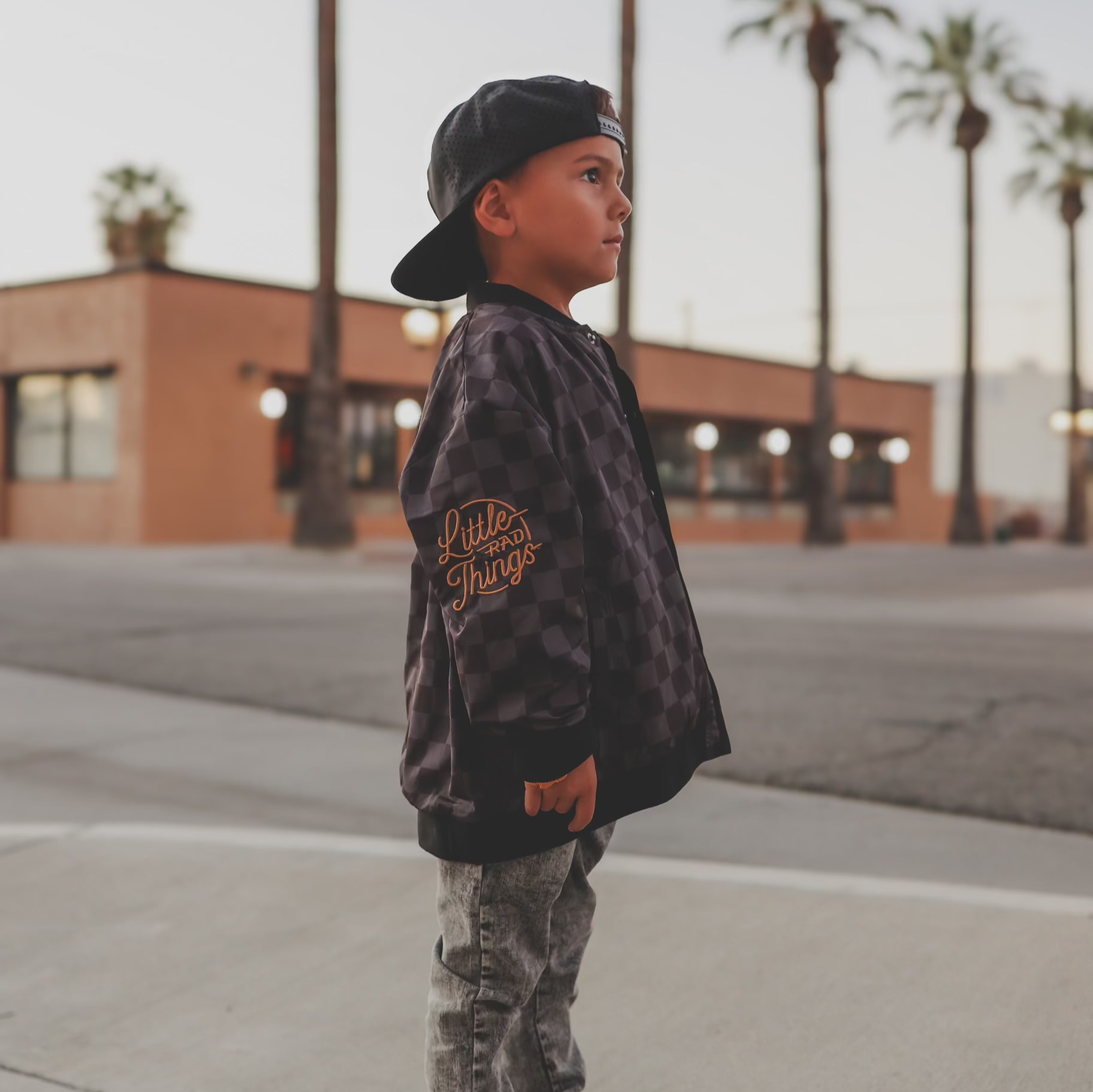 Boy in checkered letterman jacket