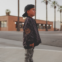 Boy in checkered letterman jacket