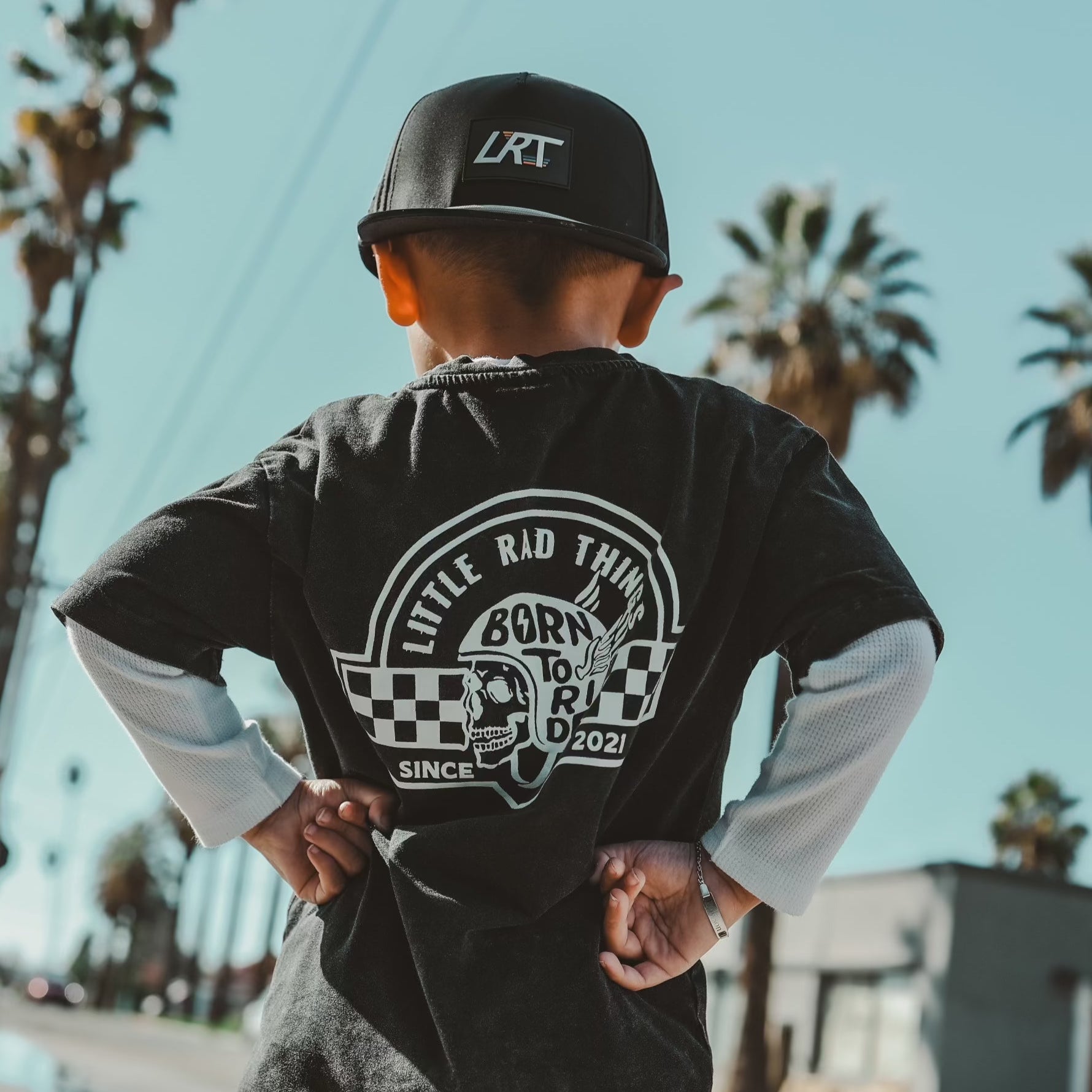 Toddler wearing 'Til Death Do We Ride' tee and LRT hat in desert landscape