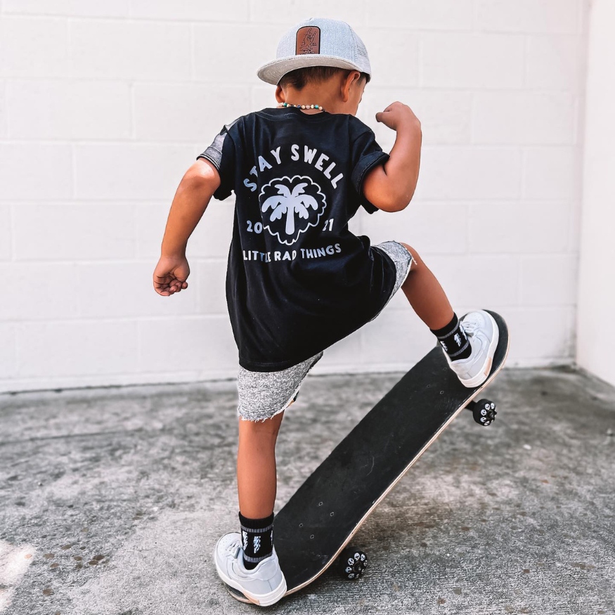 Boy in Stay Swell black tee on skateboard