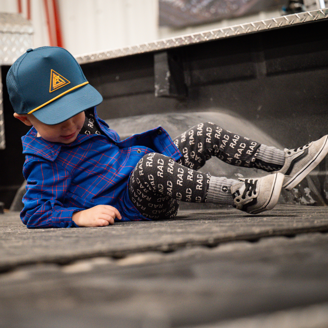 Toddler in blue plaid Kids Fast and Free Flannel with hat and patterned leggings