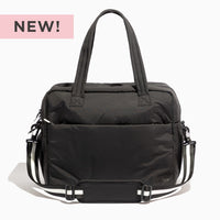 Jet Motion Overnight Duffle in black with top handles and shoulder strap, 'NEW!' badge.