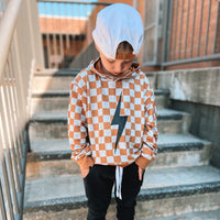 Rust checkered spark hoodie on a hanger