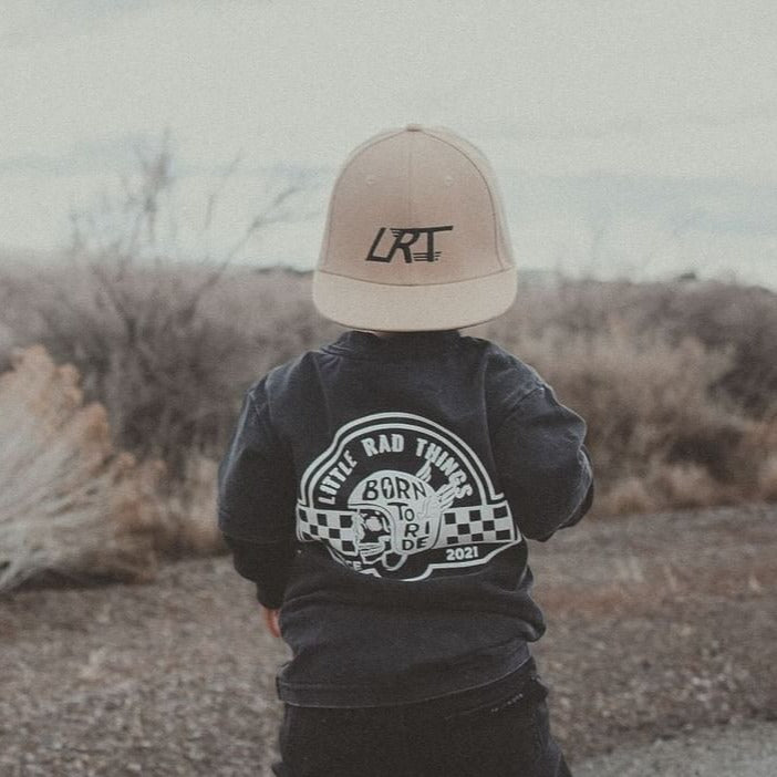Toddler wearing 'Til Death Do We Ride' tee and LRT hat in desert landscape