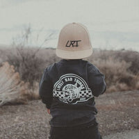 Toddler wearing 'Til Death Do We Ride' tee and LRT hat in desert landscape