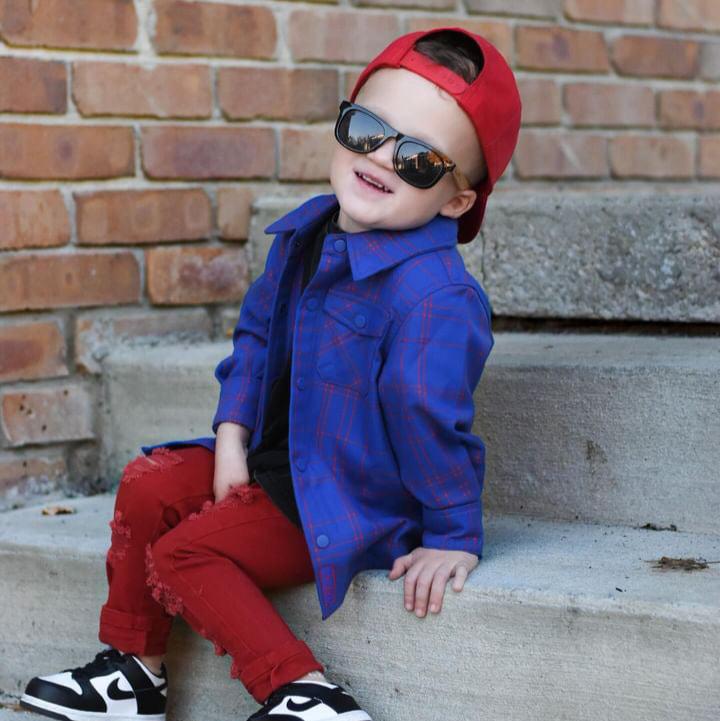 Boy in blue and red plaid Kids Fast and Free Flannel with jeans and red sneakers