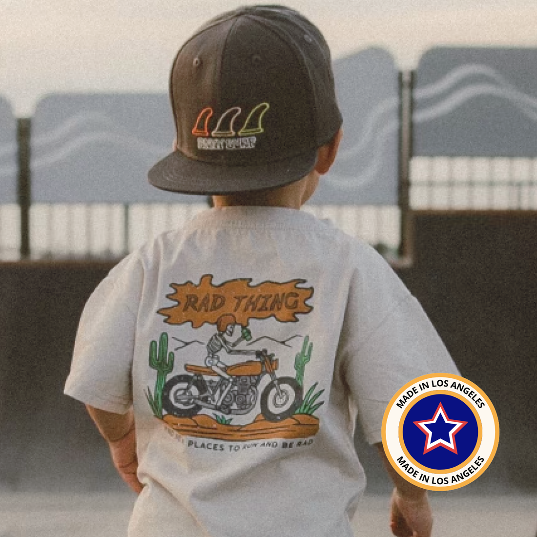 Child wearing a vintage beige 'Where the Rad Things Are' tee with a motorcycle graphic.