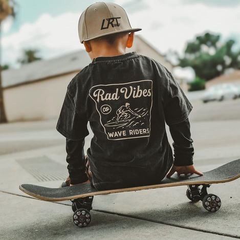 Boy on skateboard wearing Mavericks Tee vintage black with long sleeves.