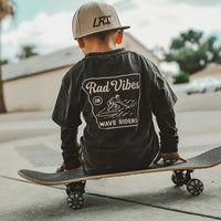 Boy on skateboard wearing Mavericks Tee vintage black with long sleeves.