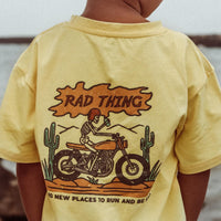 Boy wears Golden Yellow 'Where the Rad Things Are' tee with motorcycle graphic.