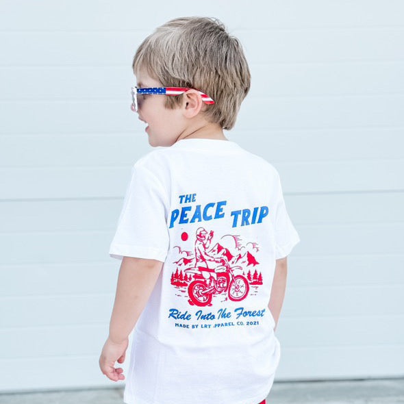 Boy wearing white Peace Trip Tee with motorcycle graphic