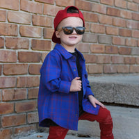Boy in blue and red plaid Kids Fast and Free Flannel with jeans and red sneakers