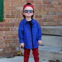 Boy in blue and red plaid Kids Fast and Free Flannel with jeans and red sneakers