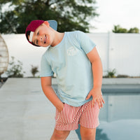 Boy in cloud blue APEX LIVE FAST tee with red and white striped shorts.