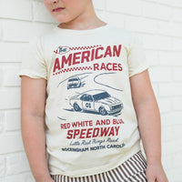 Toddler boy wearing The All American Races cream tee.