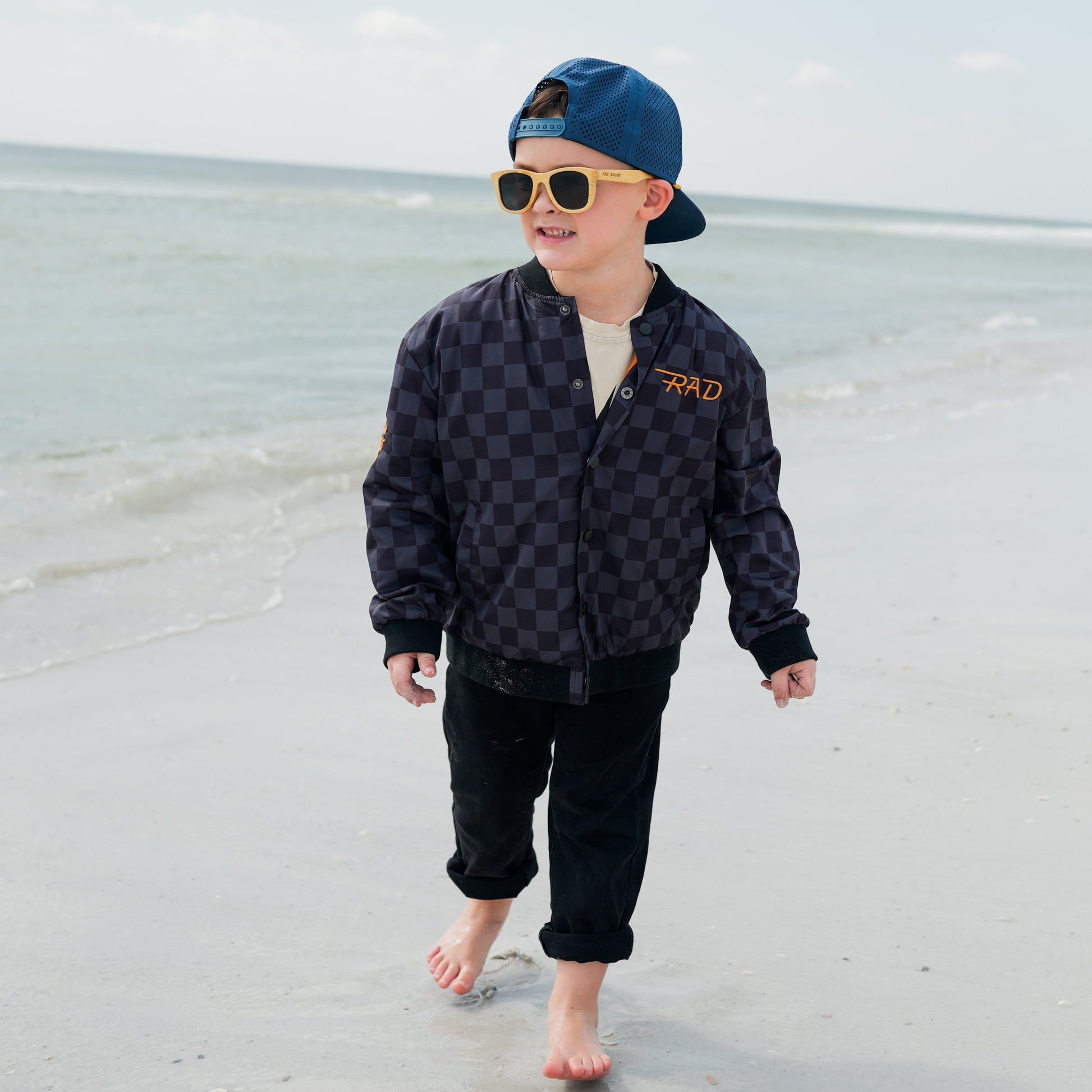 Boy in checkered letterman jacket