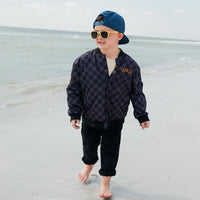 Boy in checkered letterman jacket