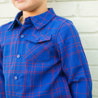 Close-up of blue and red plaid Kids Fast and Free Flannel with button pocket