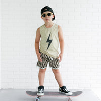 Toddler boy with lollipop wears greige Spark Muscle Tank
