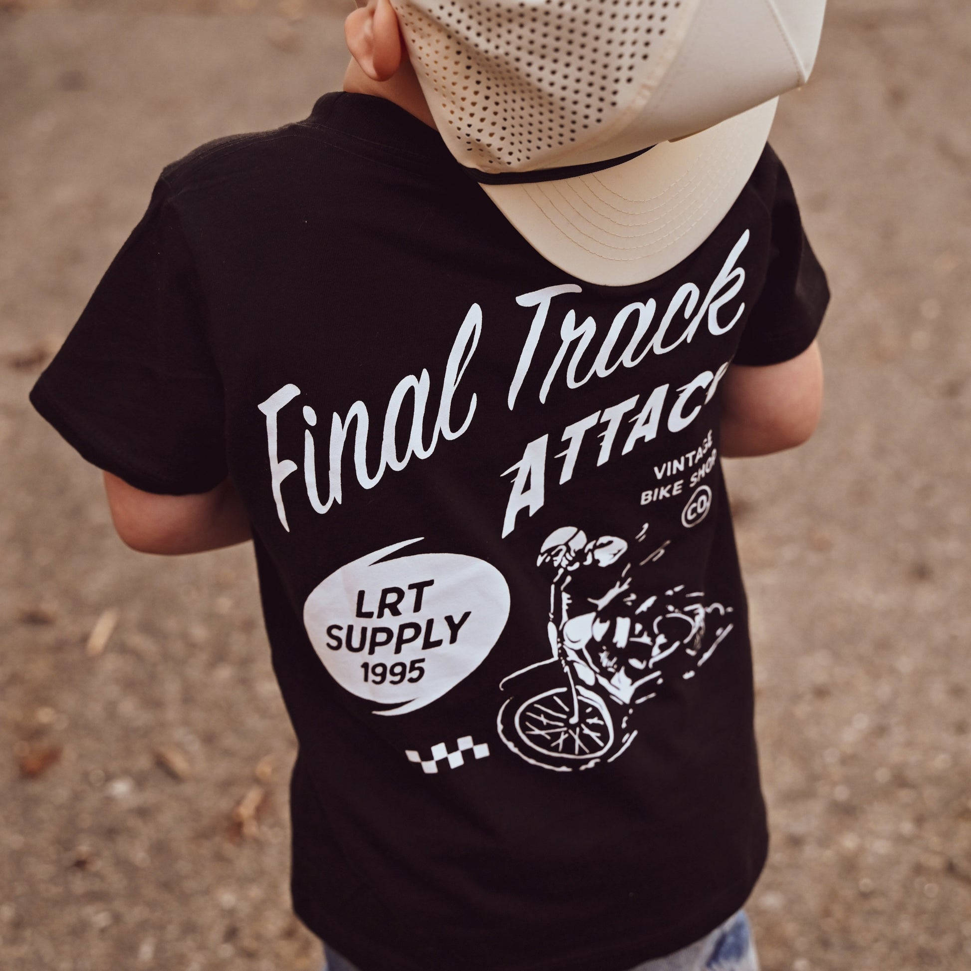 Close-up of Final Track Attack Tee back graphic on a boy.