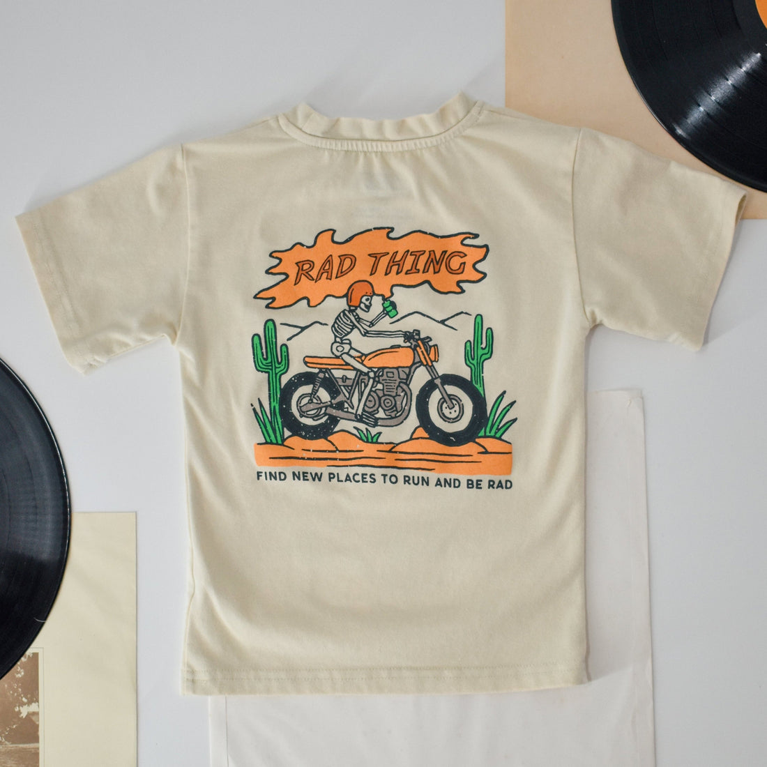 Vintage beige 'Where the Rad Things Are' toddler tee featuring a retro motorcycle graphic.
