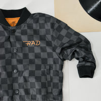 Boy in checkered letterman jacket