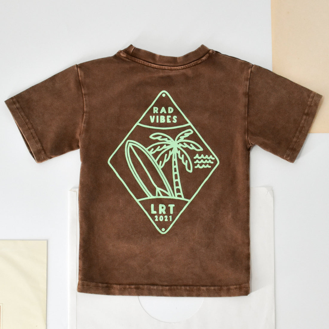 Close-up of Cocoa Beach Tee featuring 'Rad Vibes' graphic.