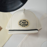 Cream Apex waterproof snapback hat with laser-cut ventilation and curved bill.