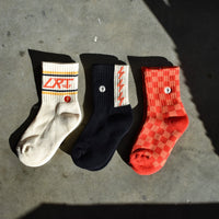 Retro kids socks: vintage-inspired designs, soft cotton blend, red/orange check, spark print, LRT logo.