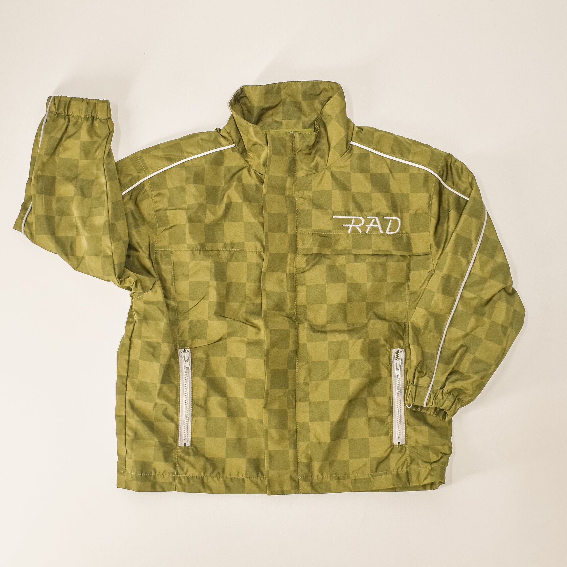 Close-up of the Storm Rider waterproof jacket in army green, featuring a checkerboard design.