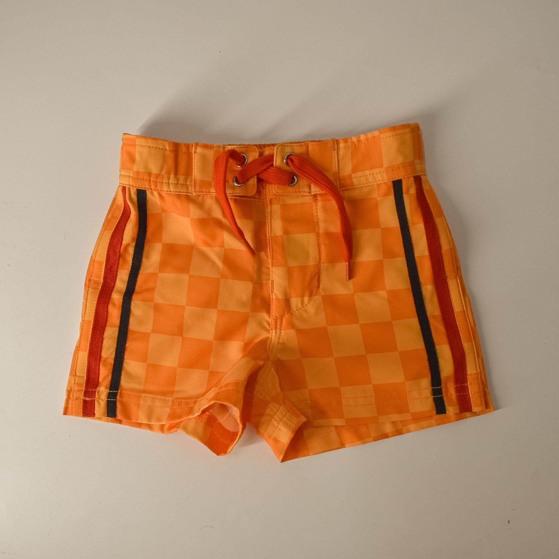 Retro-wave yellow checkerboard board shorts with a drawstring waist.