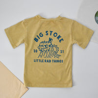 Close-up of yellow beige Cloudbreak Tee with 'Big Stoke' wave design. 