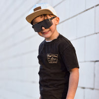 Smiling boy wearing Mavericks Tee vintage black and sunglasses.